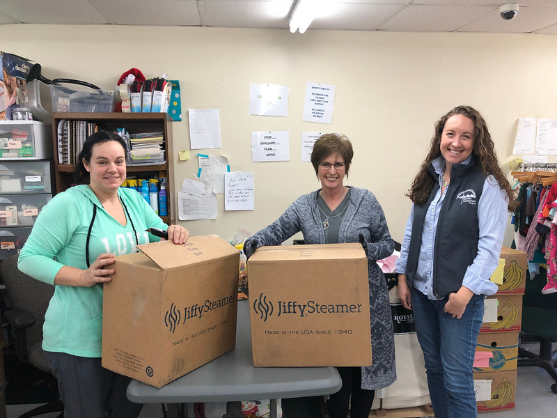 Amanda Gadd, Sherri Barnett, and Bridget McCormack with two brand-new steamers donated by Jiffy Steamer in Union City, TN.