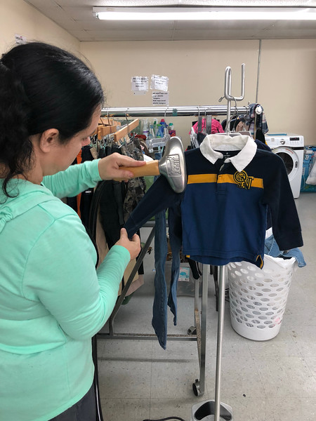 Amanda Gadd, a community volunteer, uses the new Jiffy Steamer to prepare donated clothing to go on the sales floor at Grateful Threadz Thrift Store.