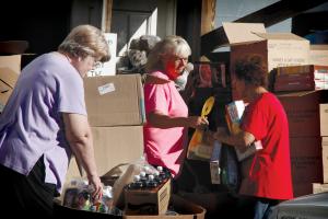 Volunteers at Abundance of Rain Ministries sort through a shipment from Operation Sharing