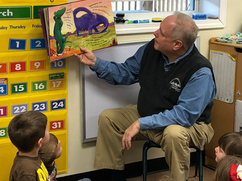 President & CEO Guy Adams reads a story to children at CAP's Child & Family Development Center