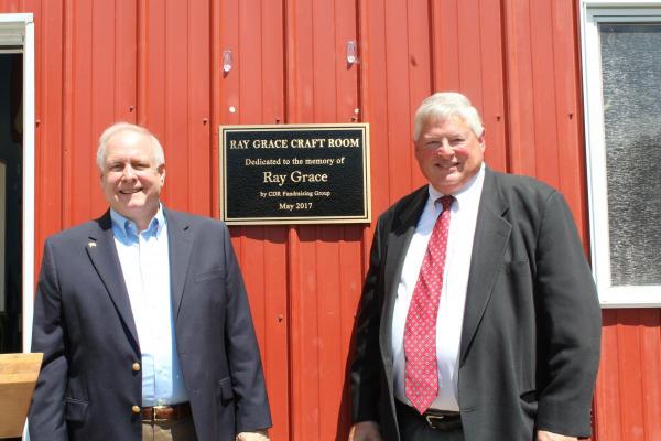Christian Appalachian Project’s President and CEO Guy Adams (left) and Geoff Peters, CEO of Moore DM Group, dedicate the Ray Grace Craft Room at Camp AJ.