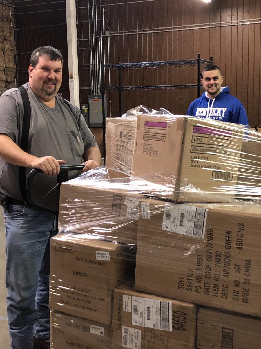 Wesley Howard, Christian Appalachian Project (CAP), collects donated toys from Josh Hager, Happen Stock Toys, to deliver to CAP’s Operation Sharing warehouse in Corbin. The toys will be distributed to children in need in Appalachia.