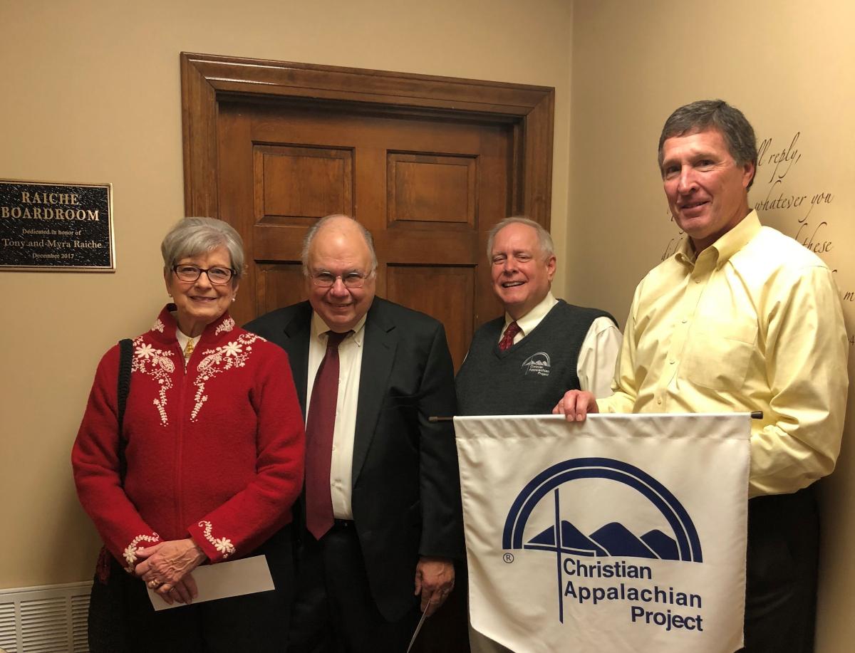 From left: Myra and Tony Raiche stand with Guy Adams, president, and Kevin Doyle, board chairman, at the presentation of the Tony and Myra Raich Boardroom at Christian Appalachian Project