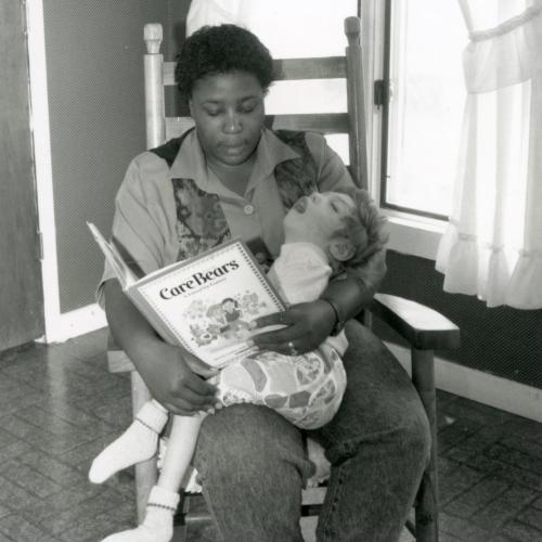 Gloria Jordan reads to a child in CAP's former Rainbow Respite program.